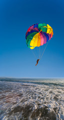 Man is parasailing in the blue sky