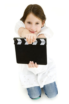 youn girl holding a movie clapper isolated on white