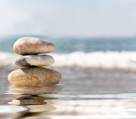 Fototapeta na wymiar Stack of pebbles on sea background