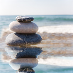 Stack of pebbles on sea background