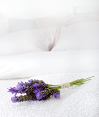 bouquet of lavender on a white towel on a bed