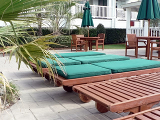 loungechairs at a resorts poolside courtyard