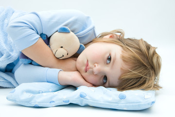 little, sleepless, girl lying in bed with teddy bear