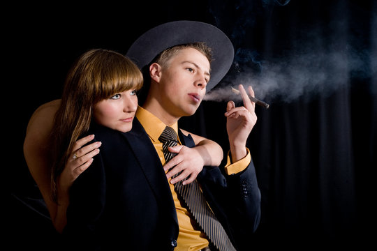 An image of woman and man with cigar