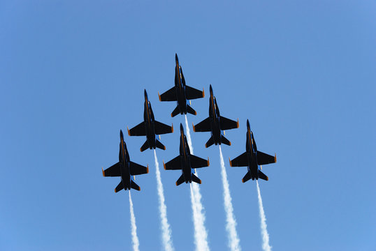a formation of airplanes on a blue sky