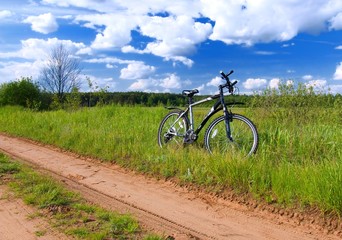 Bicycle by side of track in summer rural scene