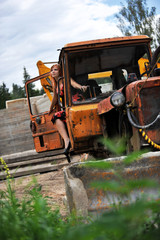 Beautiful young woman on tractor