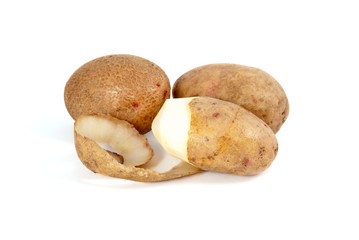 Potatoes. Whole and half-peeled isolated on the white background