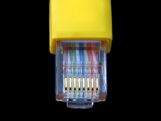 Yellow utp cat5 network cable isolated on black background