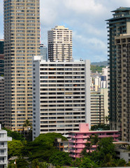 Fototapeta na wymiar Little pink hotel among the towers just off Waikiki Beach