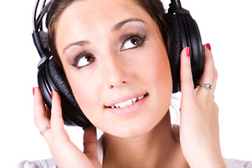 Fototapeta premium Young woman with big headphones. Isolated on white.