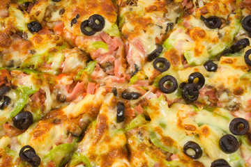 Close up of sliced supreme pizza