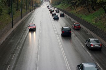 Cars passing by on a wet road in the rain