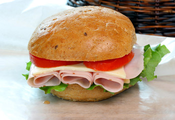 Tukey, lettuce and tomato on a rye roll sandwich