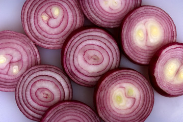 Onion rings sliced and laid out on a chopping board