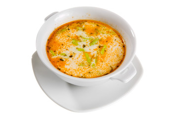 soup with green spice in white bowl