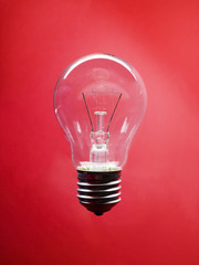 Lightbulb on red background