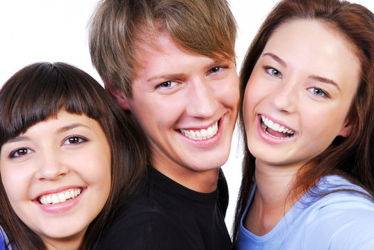 Isolated portrait of three beautiful teenagers laughing