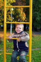 Obraz premium The cheerful little boy playing at playground