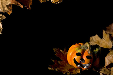 Pumpkins, autumnal leaves ad ghosts on a black