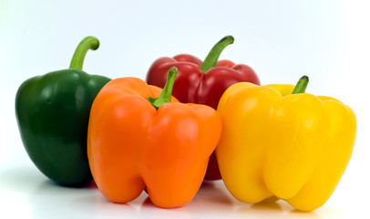 Four different colors of peppers isolated on white