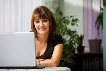 young woman with a laptop in the living room