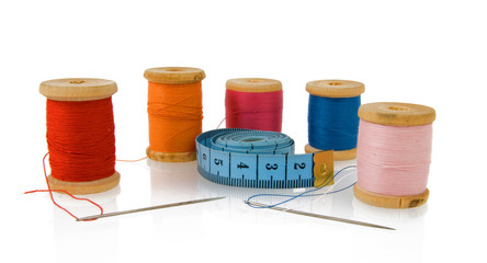Reels of thread with tape measure on white