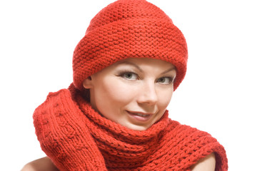 winter portrait of a beautiful young woman in red hat