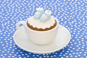 Christening cupcake with blue booties for a boy