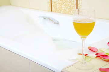Still-life a glass with a drink against a bath with foam