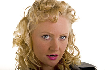 A close up of a woman with curly blonde hair and bright eyes