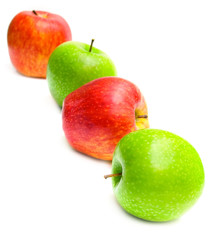 The green and red apples on white. Isolation, shallow DOF.