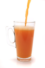 big glass filled orange juice