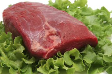 fresh red meat on green salad leaf