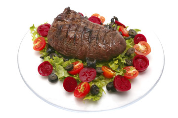roast meat and vegetables on transparent dish