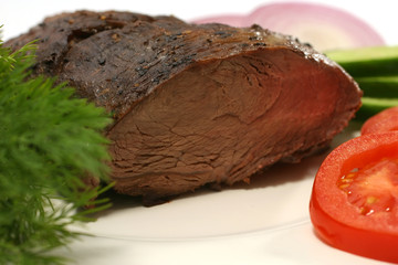 roast meat piece and vegetables