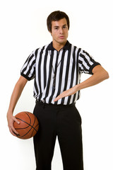 Young male basketball referee calling a foul