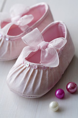 closeup of pink satin baby shoes
