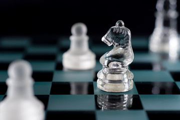 A shot of a chessboard with focus on the horse