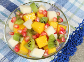 Fruit salad with kiwi, mango, pear and pomegranate