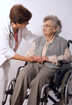 Health care worker and elderly woman in wheelchair