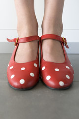 close-up of feet in red shoes with white dots
