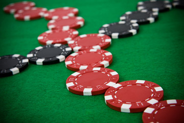 Crossed lines of red and black poker chips.