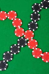 Crossed lines of red and black poker chips.