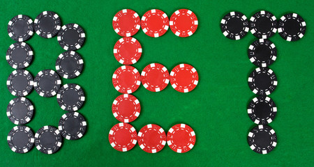 Bet - word build using red and black poker chips.