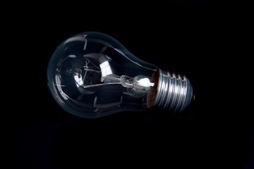 Classic light bulb isolated on black backgound.
