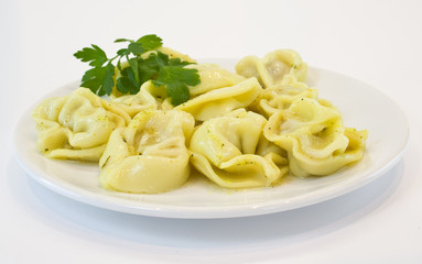 dumplings on a white plate with parsley