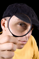 Investigator looking through magnifying glass