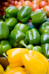 A bluk bin of peppers at an outdoor market