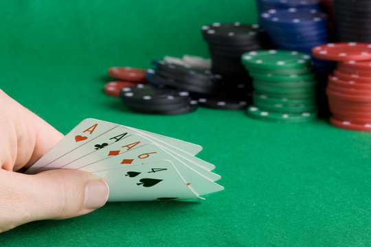 A poker hand with three of a kind Aces